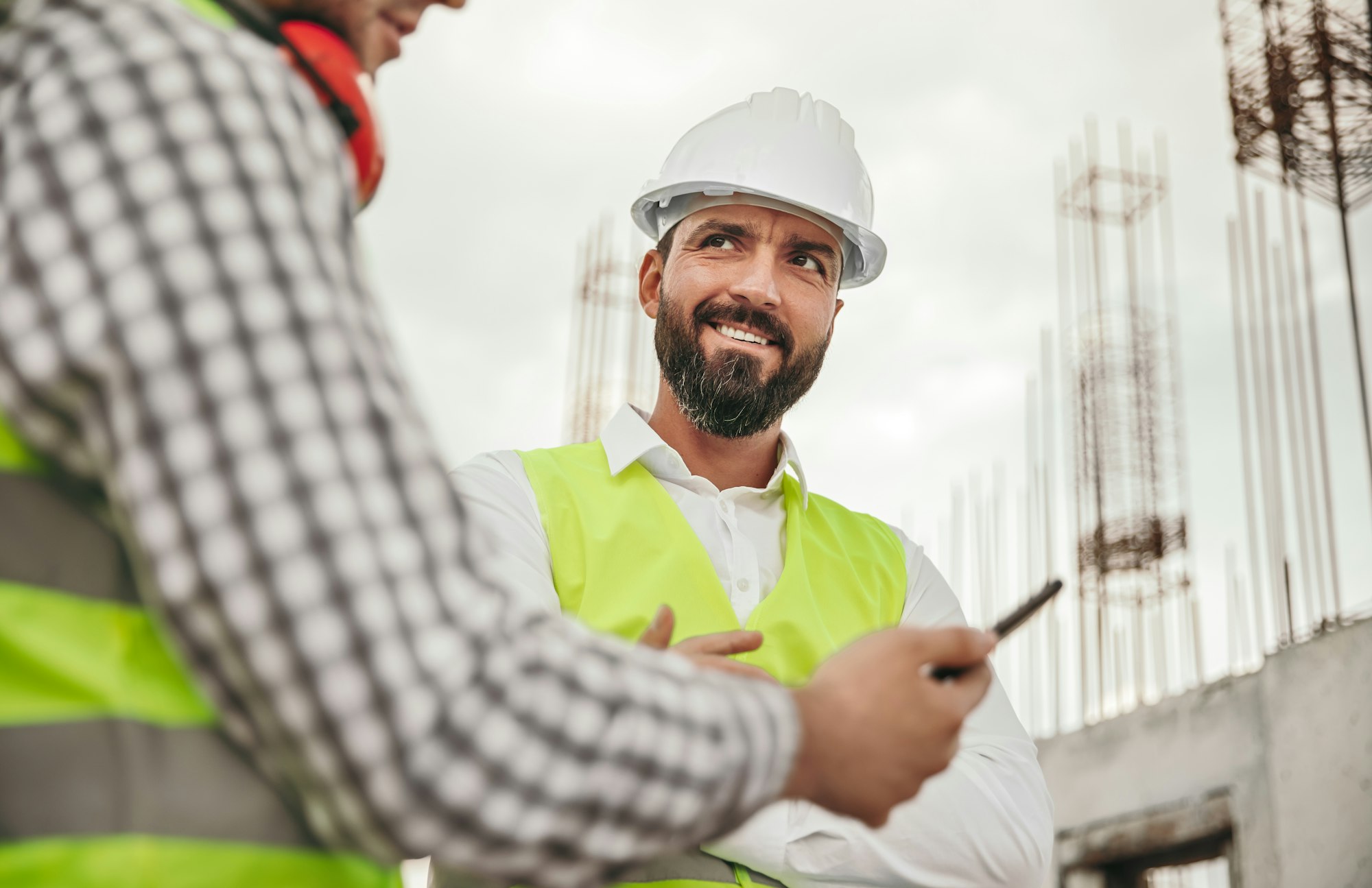 Bearded contractor speaking with colleague