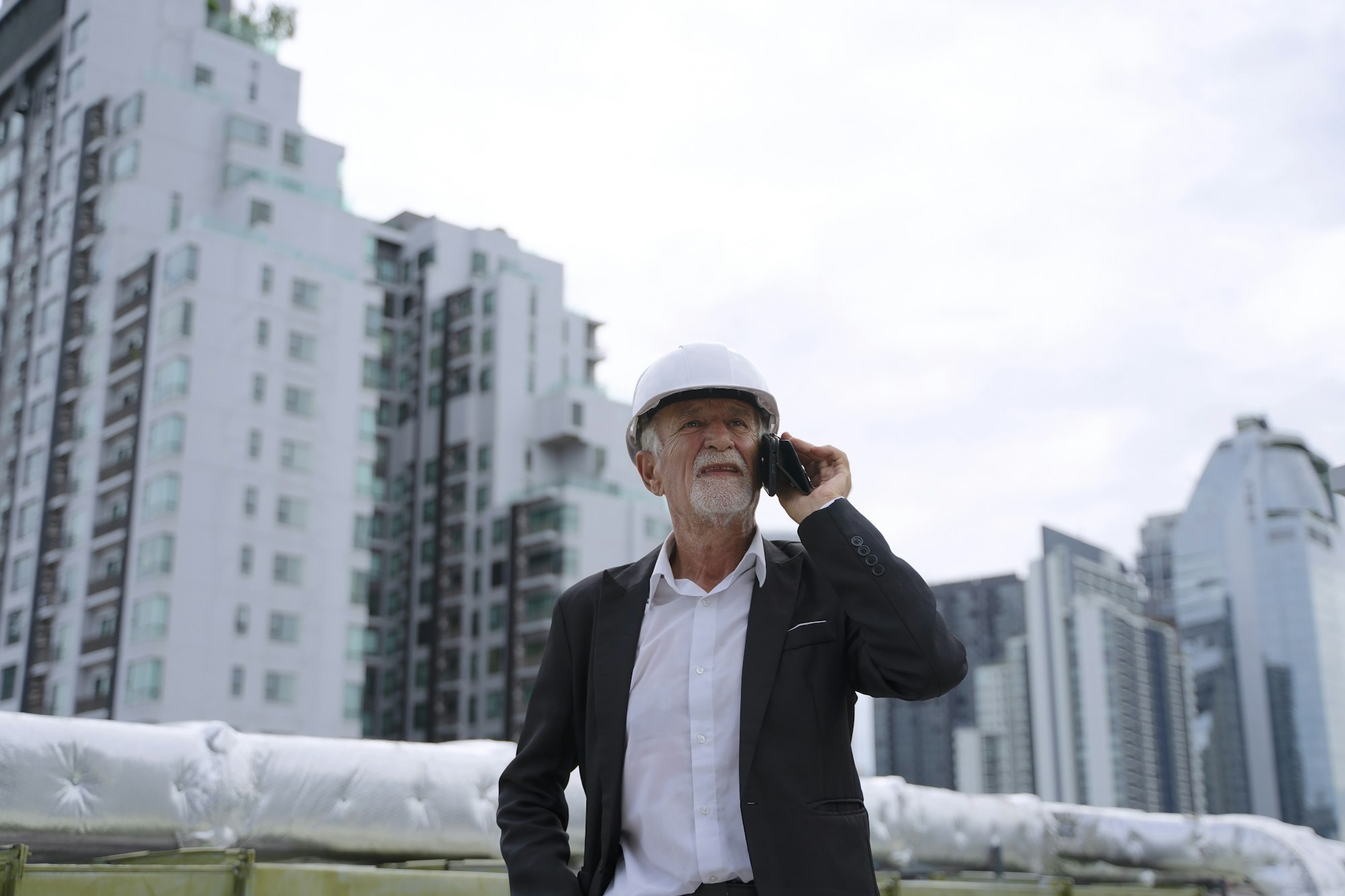 Engineer is working on the rooftop of high rise building.