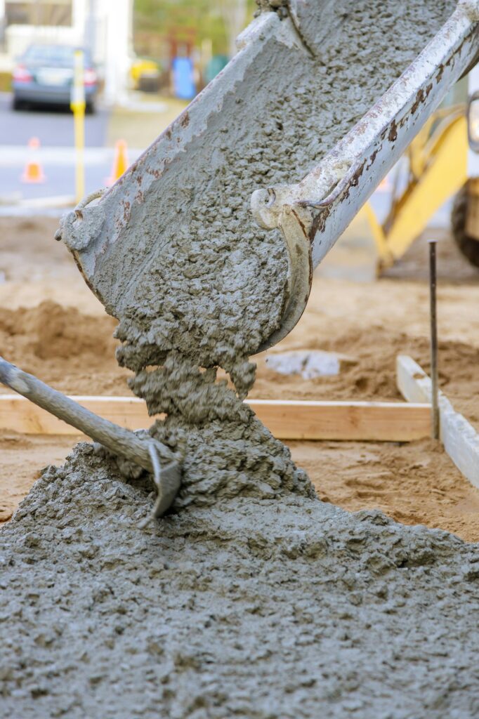 Concrete truck with pouring cement during to residential street sidewalk