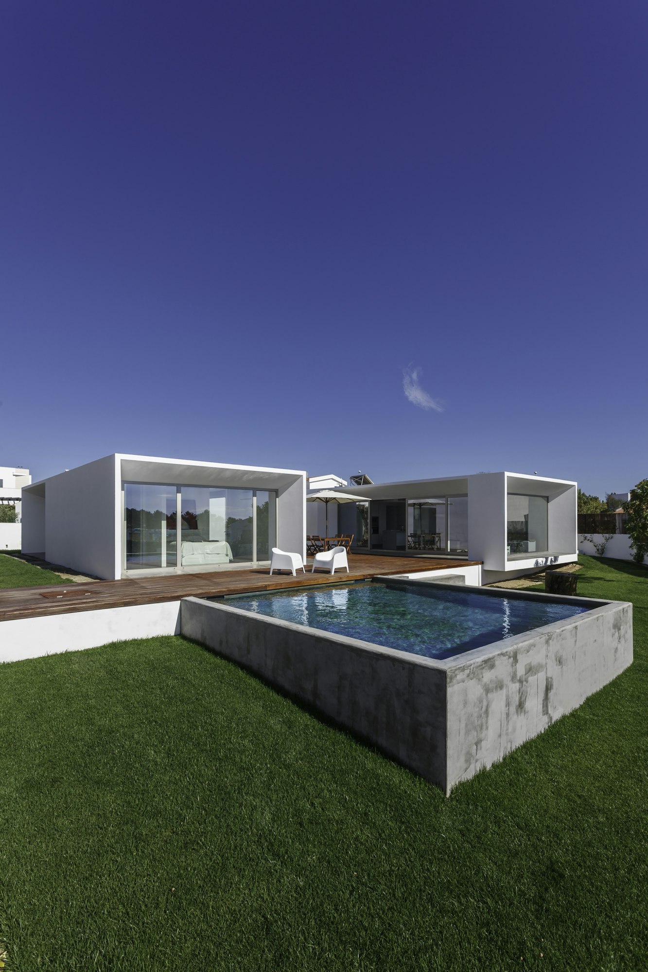 Modern house with garden swimming pool and wooden deck